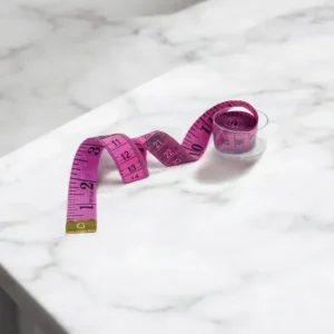 Сантиметр кравецький в пластиковому контейнері двосторонній Рожевий 150/60 сантиметри/дюйми